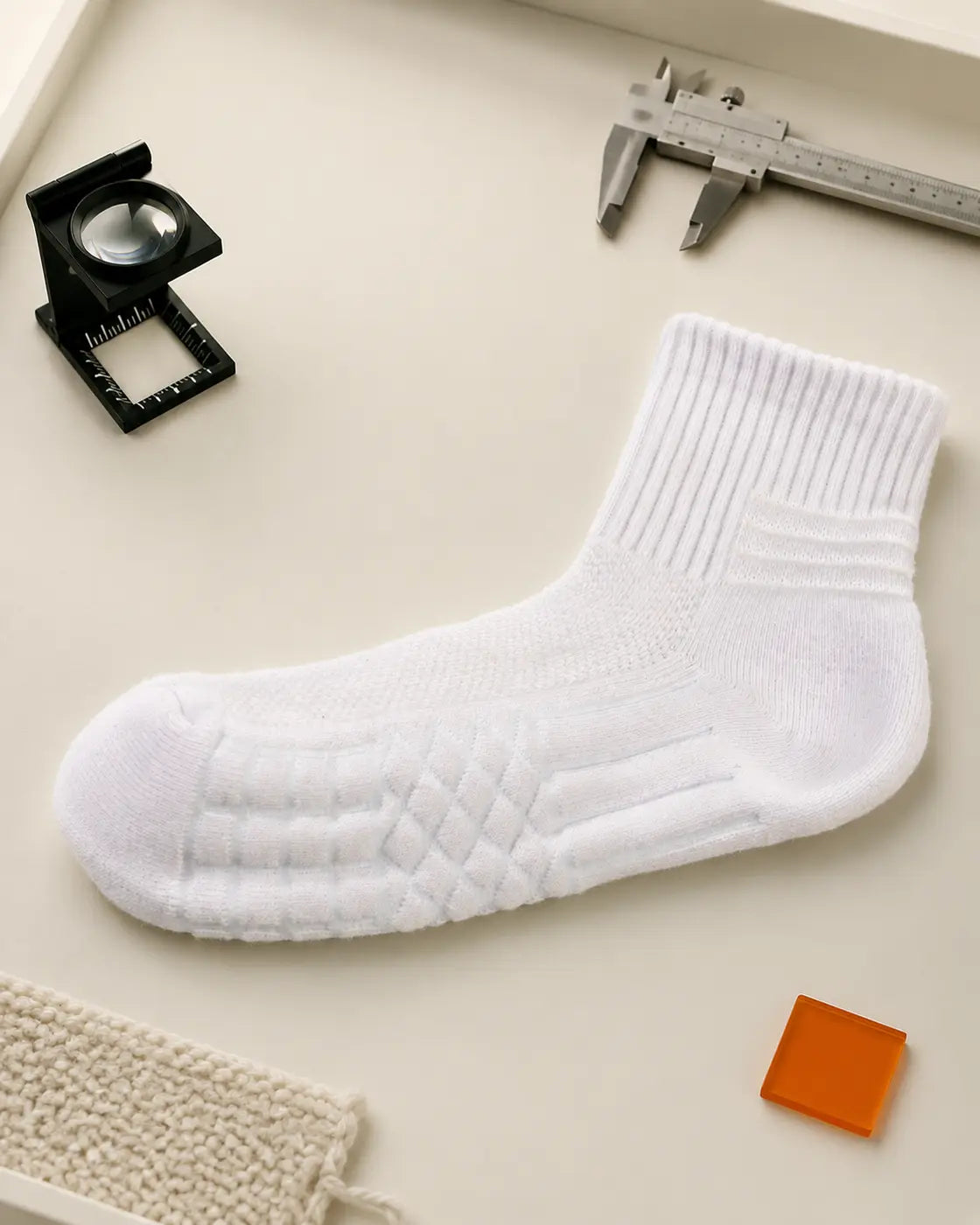 Photographed D7 ankle sock laid flat for inspection on a quality-control bench