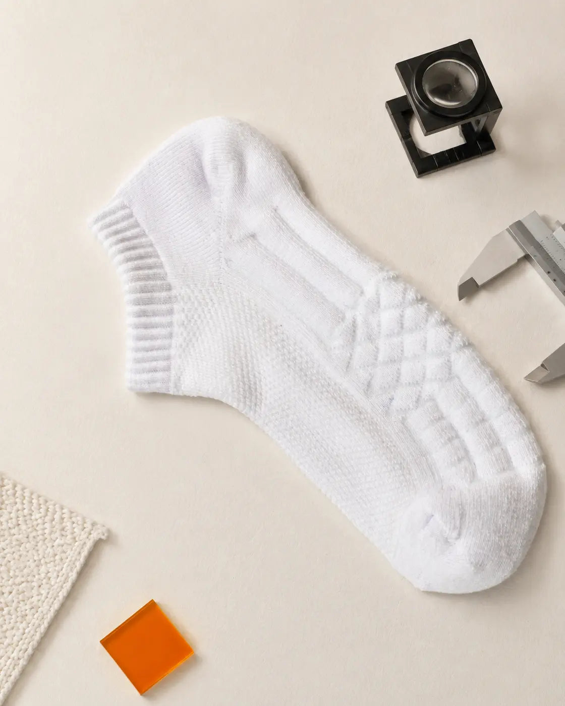 Photographed D7 ankle sock laid on a laboratory observation bench, showing its knit and cushioning structure